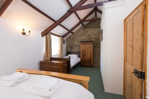 Bedroom 1 sleeps 3 in king-size and single beds, there is space for a cot also