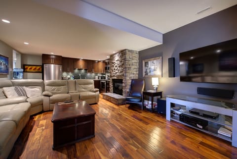 Living room, Leather sectional full cable, movies etc 65" new TV. Fireplace