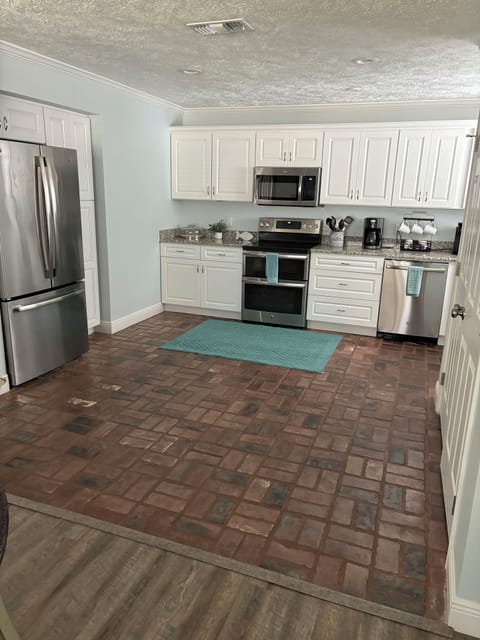 Spacious kitchen, real brick floors