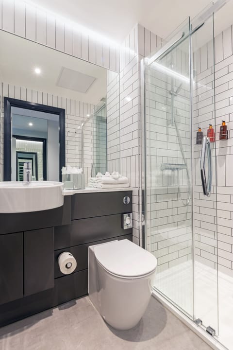 Shower, designer toiletries, hair dryer, towels