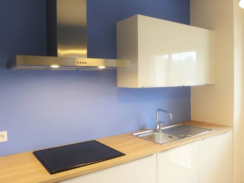 Countertop, Property, Room, Kitchen, Furniture, Interior Design, Yellow, Lighting, Cabinetry, Architecture