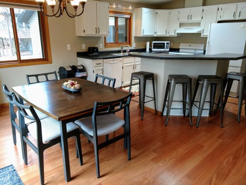 Dining room table expands to seat up to 10 place settings, plus 4 bar stools.