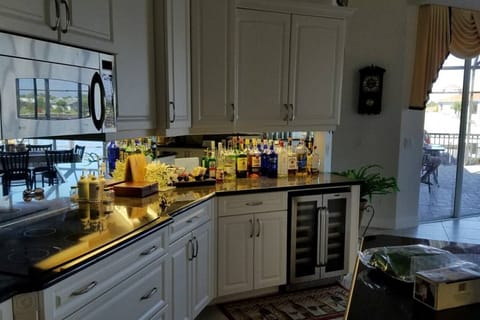 kitchen bar area with wine cooler