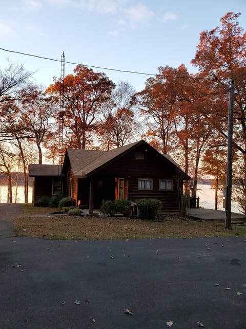 View of Lake House, from the paved driveway, as the sun has set for the day