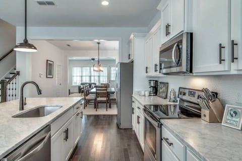 Kitchen fully stocked with all cooking essentials, oven, dishwasher, microwave, stove and drop coffee maker