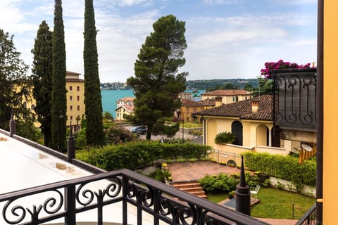 Superior Quadruple Room, Balcony, Lake View | Minibar, in-room safe, desk, blackout drapes