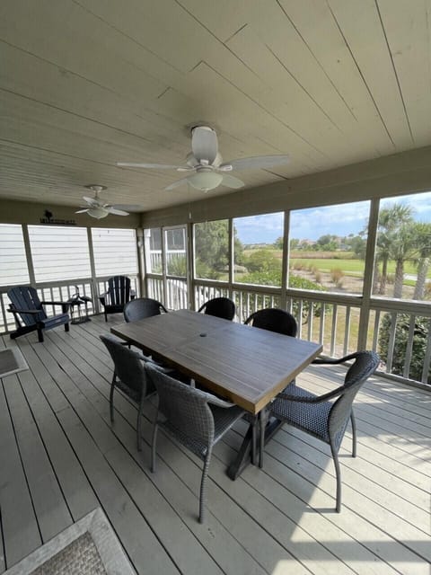 The porch has an outdoor dining area for 6 and 2 Adirondack chairs.