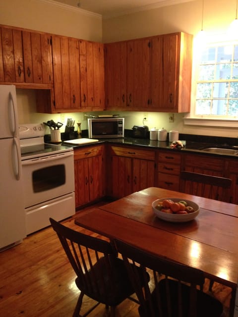 Fully equipped kitchen: microwave, coffee maker, condiments.