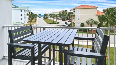 Dine outdoors on the balcony with a Gulf view.