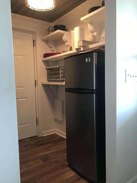 DOWN STAIRS FRIDGE AND KITCHEN AREA