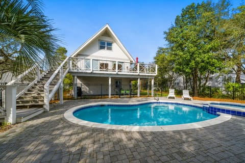 Charming coastal cottage with private pool surrounded by lush tropical landscaping creates your perfect beach getaway retreat.