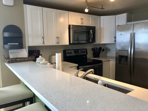 Beautiful quartz countertops kitchen has ocean and beach view 