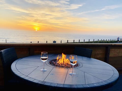 Fire table and chairs on the deck with sunset view