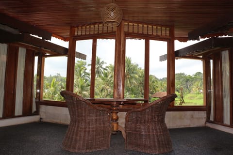 The Balcony sitting area with pool and rice terrace view