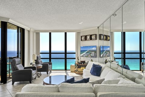 Floor-to-ceiling windows w/ shades that pull all the way back allow great views throughout the living room and kitchen
