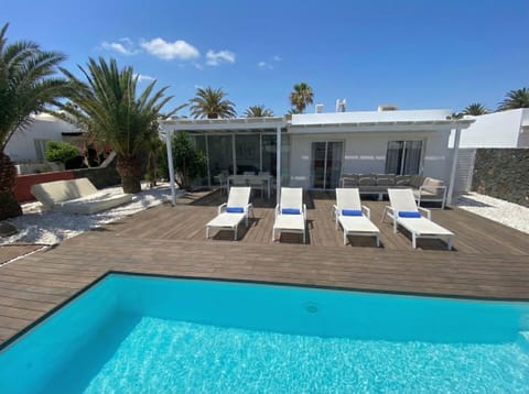 Your private oasis: turquoise pool surrounded by elegant wooden decking, perfect for your vacation.
