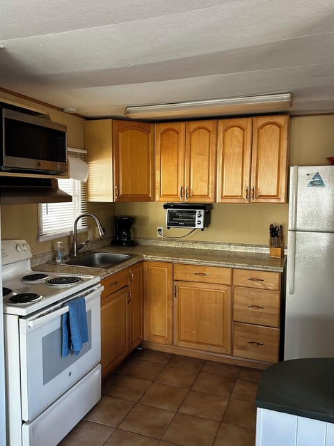 Fully equipped kitchen with microwave, coffee maker, rice cooker, and blender