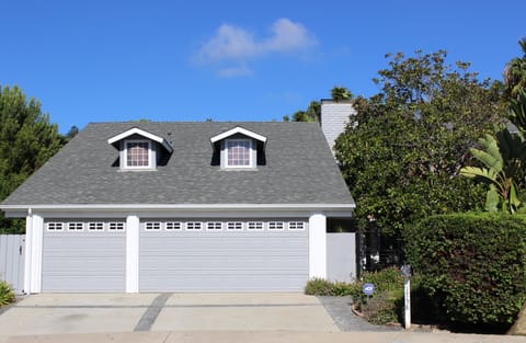 3 car garage, outdoor shower on left side yard, tree swing in courtyard on right
