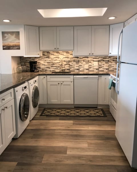 Under-counter washer and dryer in kitchen