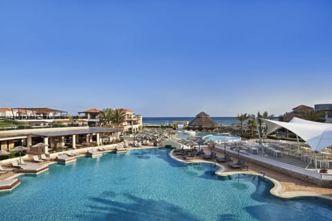 Seasonal outdoor pool, open 10:00 AM to 6:00 PM, pool umbrellas