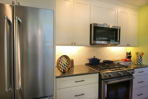 The kitchen features a 22 sq ft refrigerator and pro- line gas range.