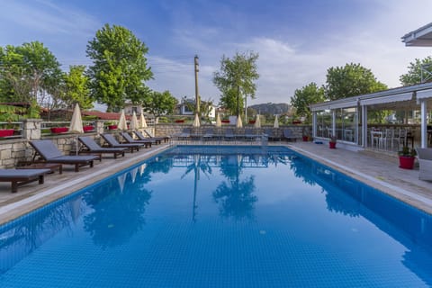 Seasonal outdoor pool, open 9:00 AM to 6:00 PM, pool umbrellas