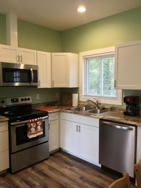 Large, fully stocked kitchen with stainless steel appliances.