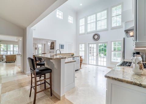 Seating for 5 at the kitchen bar. Coffee station w/ Keurig & Nespresso w/ pods.