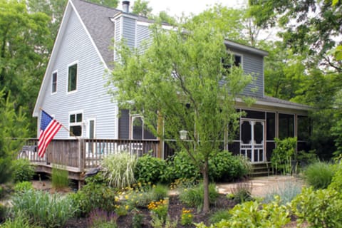 Front of lovely wooded retreat with standout outdoor spaces. Click for full pics