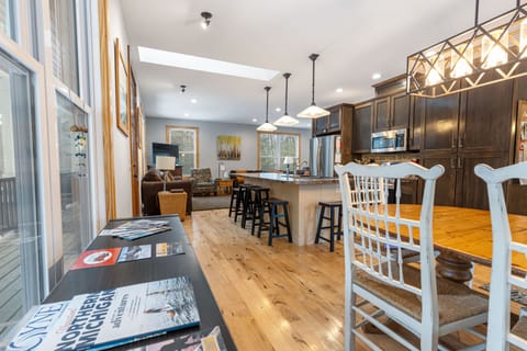 Plenty of seating for your group - Bar stool, large kitchen table in dining area plus an additional round table/chair set on other side of living room.  Plus, the doorwall opens to outdoor dining on the wrap around porch.