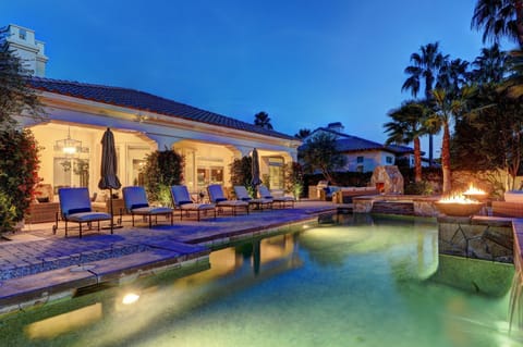 Private, resort-style backyard with fireplace, custom BBQ island, ample seating and al fresco dining.