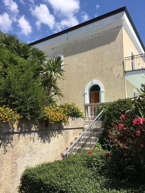 Main entrance, flower garden, and steps down to the pool level