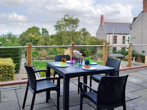 Flagged terrace with table and chairs | Zonnebloem, Brymbo, near Wrexham