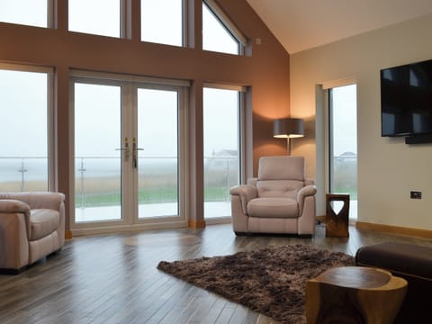 Living room with 65 inch Sky Q Smart TV | Skipper&rsquo;s Retreat, Clachan Sands, Isle of North Uist
