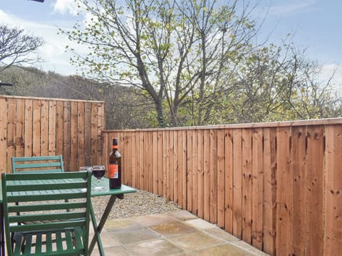 Private outdoor space with table and chairs | Pheasant Lodge, Staithes, near Whitby