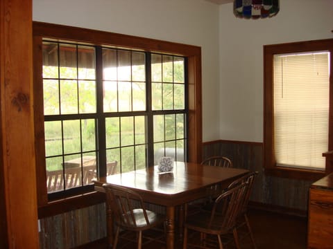Dining area looks out to front porch. Extra leaves are available for table.