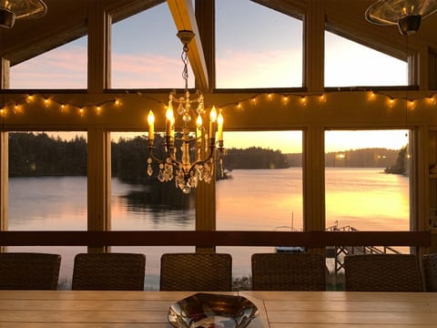 Enjoy the sunset on the covered deck under a chandelier.