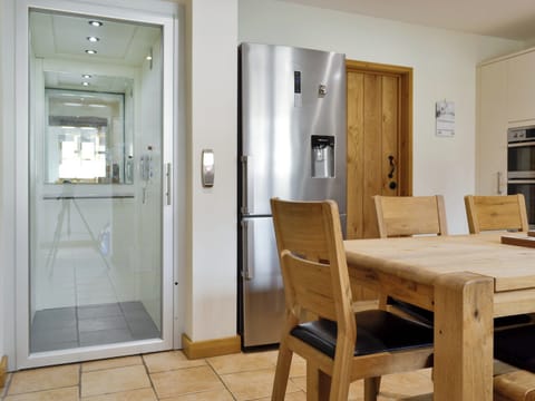 Kitchen/diner with lift to first floor | Ysgubor, Pwllglas, near Ruthin