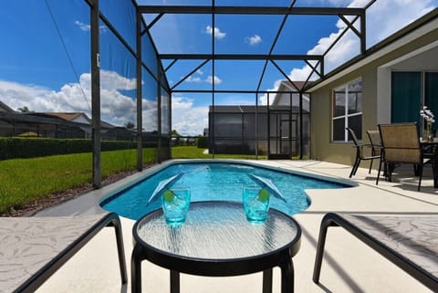 Relax by the sparkling pool with screened enclosure and sunny views.