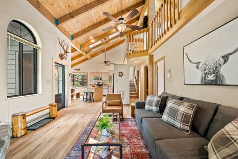 Living Room Beyond the Den with TV and Loft Above