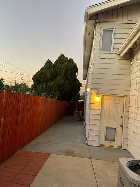 Backyard walkway leading towards the swimming pool from the back door