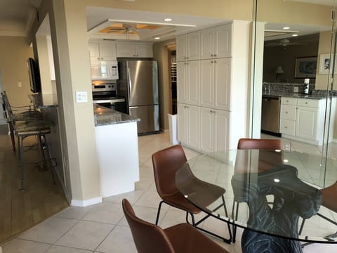 Breakfast bar on the left, looking into kitchen and dining table 