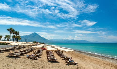 Private beach, black sand, sun loungers, beach umbrellas