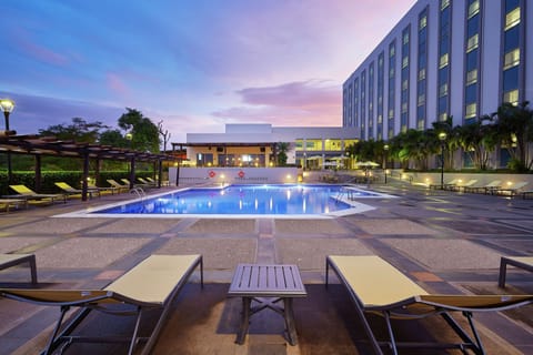 Outdoor pool, open 6:00 AM to 11:00 PM, pool umbrellas, sun loungers