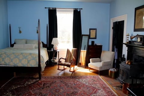 Master bedroom with king size bed and wood stove.