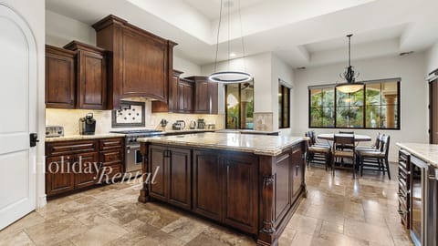 Beautiful kitchen with wood cabinetry, granite counters & spacious island!