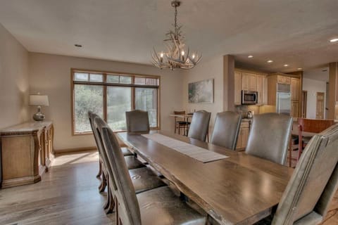 The table has enough room to sit 9 with an additional 8 seats around the kitchen island bar