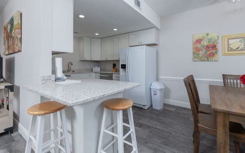Enjoy preparing meals in this stylish kitchen, featuring sleek countertops, stainless appliances, and a welcoming dining area