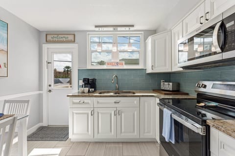 Our full kitchen Features stainless steel appliances including large fridge, stove, oven, blender and  microwave (Note: no dishwasher).