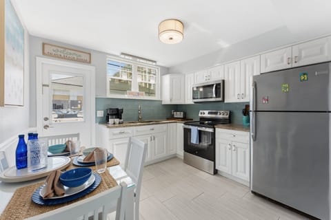 Our full kitchen Features stainless steel appliances including large fridge, stove, oven, blender and  microwave (Note: no dishwasher).